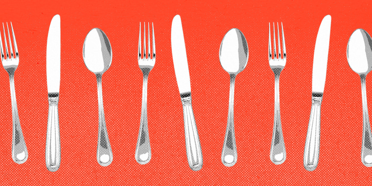 Tenedor, cuchillo y cuchara se alinearon sobre fondo rojo.