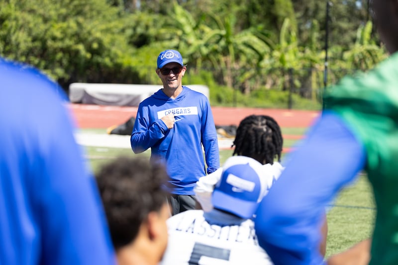 El coordinador ofensivo de BYU, Aaron Roderick, habla con los jugadores durante la práctica en las instalaciones de entrenamiento al aire libre de BYU en Provo.