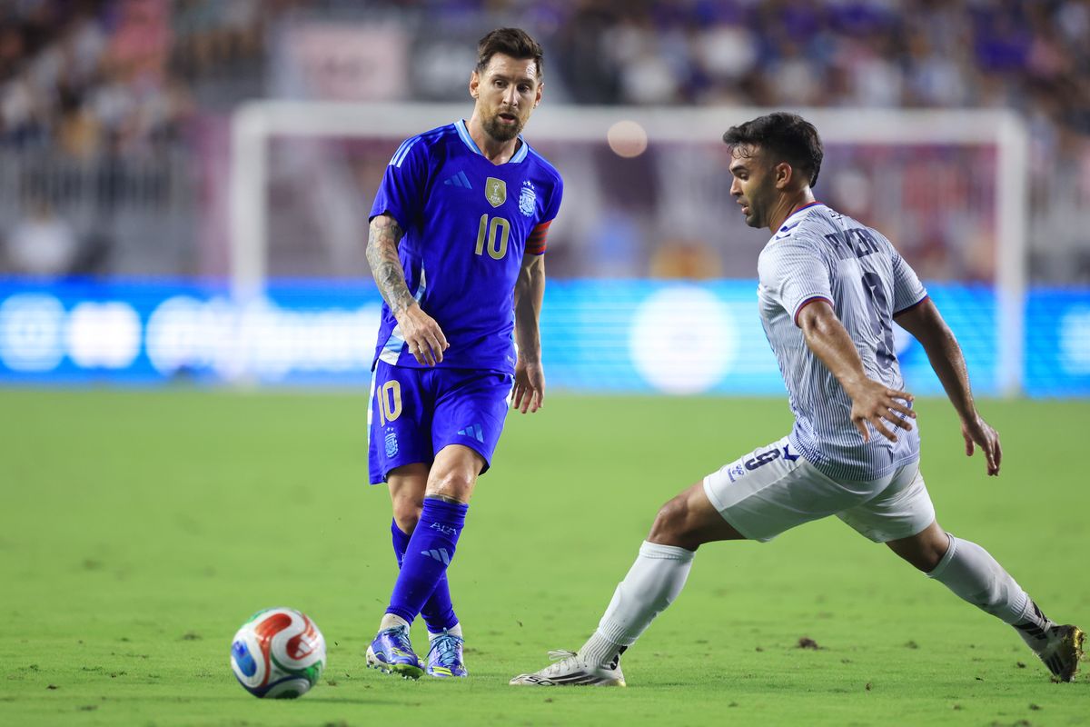 Lionel Messi de Argentina es desafiado por Ricardo Rivera de Puerto Rico durante un partido amistoso internacional entre Puerto Rico y Argentina en Chase Field el 14 de octubre de 2025 en Fort Lauderdale, Florida.
